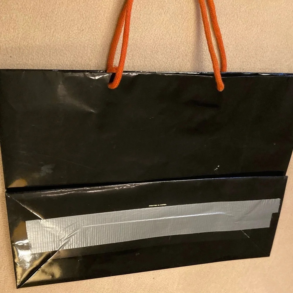 Guy Laroche Paris,black gloss glazed paper branded shopping tote,orange handles